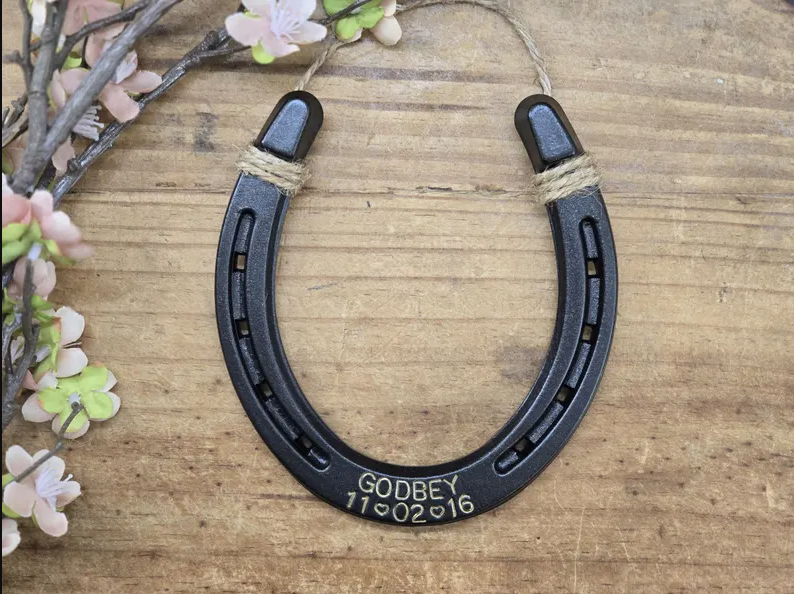 Real horseshoe painted an oil-rubbed bronze color and engraved with a last name and date.