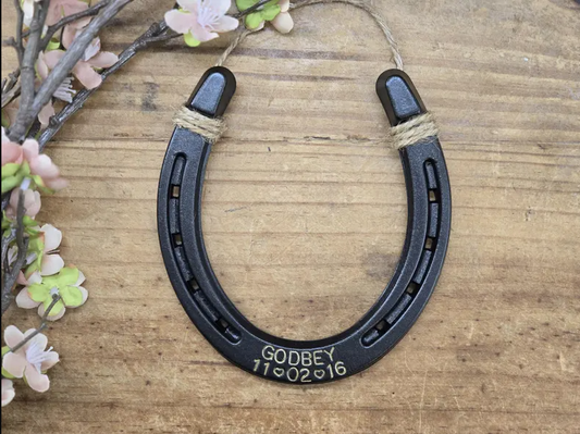 Real horseshoe painted an oil-rubbed bronze color and engraved with a last name and date.