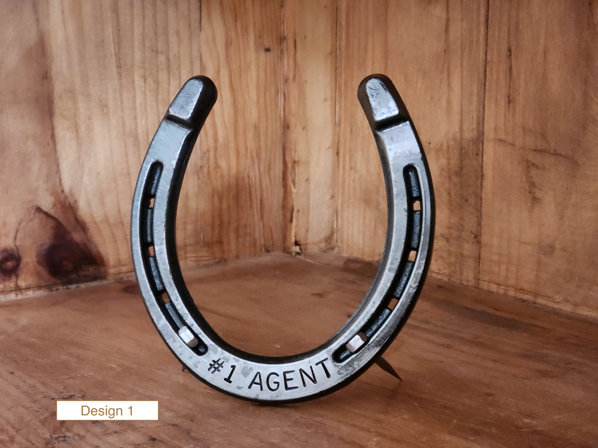 Real horseshoe made into an award with custom text along the bottom. Displayed with nails for a freestanding design.