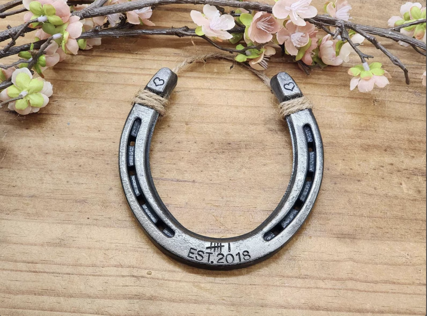 Real horseshoe stamped with 6 tally marks along the bottom and Est 2018 to represent 6 years. Hearts are stamped on the upper corners of the horseshoe.