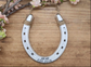 Personalized aluminium painted horseshoe with 10 tally marks and 'EST. 2014' engraving along the bottom and jute twine accents, perfect as a rustic 10 year anniversary gift or home decor piece.