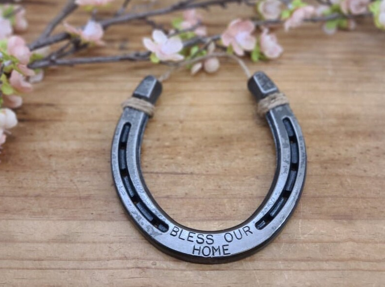 Real horseshoe decor with 'BLESS OUR HOME' stamped along the bottom