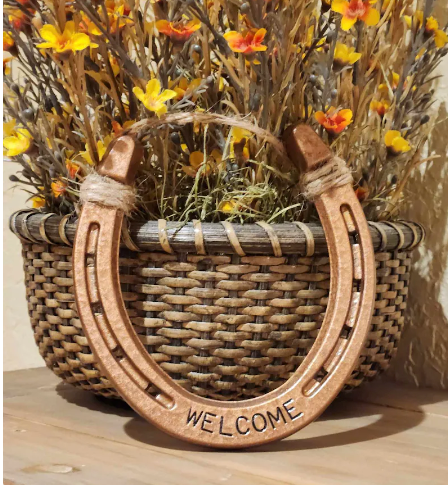 Real horseshoe decor painted copper and stamped with 'WELCOME' along the bottom