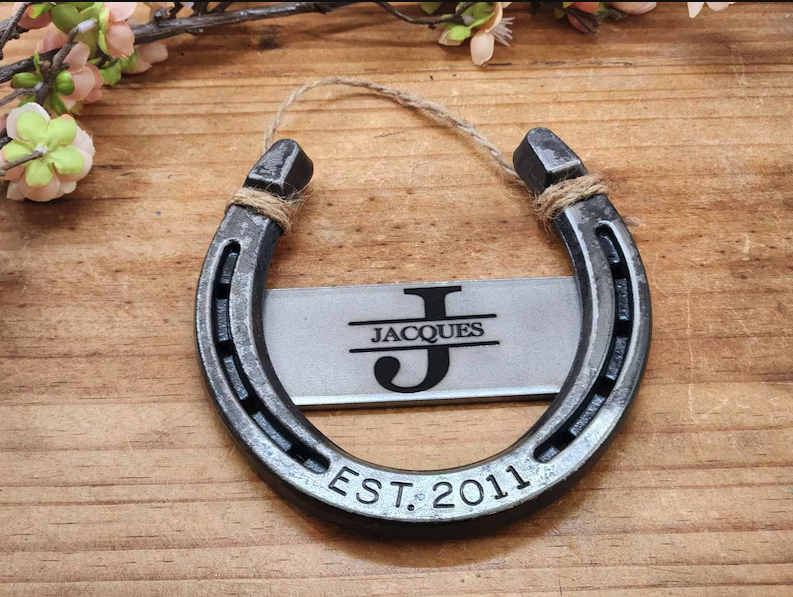 Real horseshoe with custom monogram in the center and the anniversary year engraved along the bottom of the horseshoe.