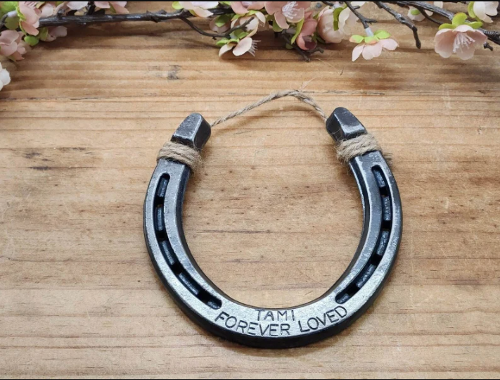 Real horseshoe engraved with a special phrase to honor the life of a beloved horse. Jute string attached at the top for hanging.