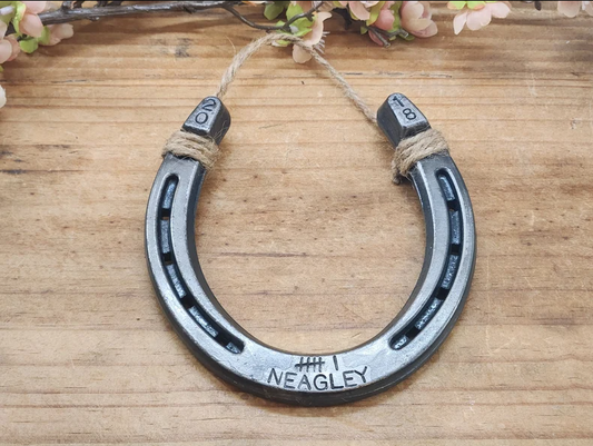 Unique handmade horseshoe decor with 6 tally marks and a last name stamped along the bottom and the anniversary year stamped in the upper corners.