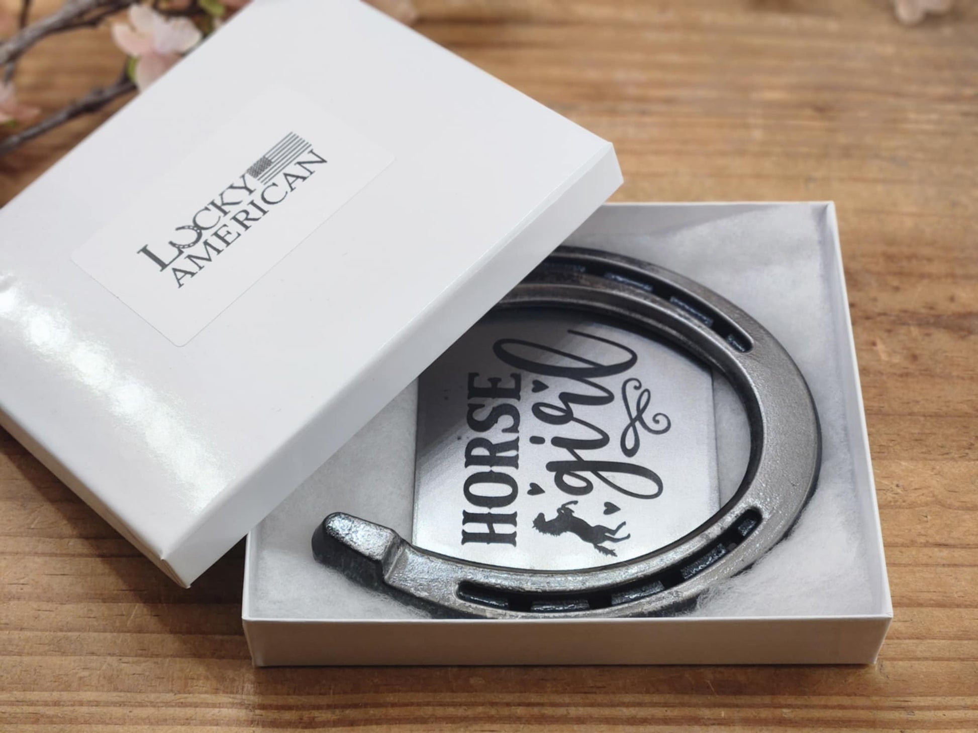 Real decorative horseshoe with center image showing the words Horse Girl and the silhouette of a horse and hearts. Displayed in a white gift box. 