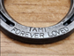 Close up photo of the bottom portion of a real horseshoe to show the saying 'Forever Loved' along the bottom.