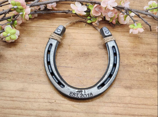 Real horseshoe stamped with 6 tally marks along the bottom and Est 2018 to represent 6 years. Hearts are stamped on the upper corners of the horseshoe. 