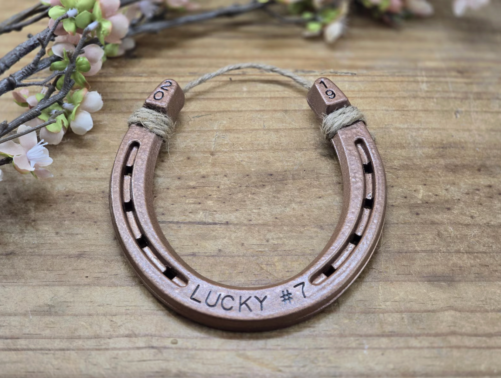 Authentic horseshoe spray painted copper and handstamped with LUCKY #7 along the bottom and the year in the upper corners