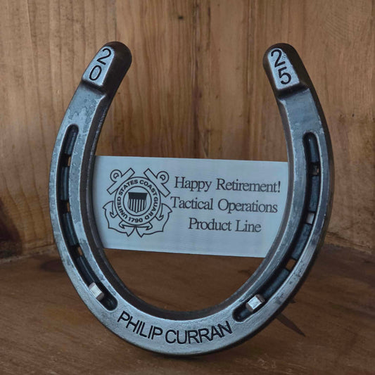 Real horseshoe with custom engraving on a metal plate, the heels and along the bottom.