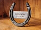 Real horseshoe with horse's name and 'LOVED BY' plus the owner's name engraved on a center metal plaque welded to the back of the shoe. Engraved with date of passing along the bottom.