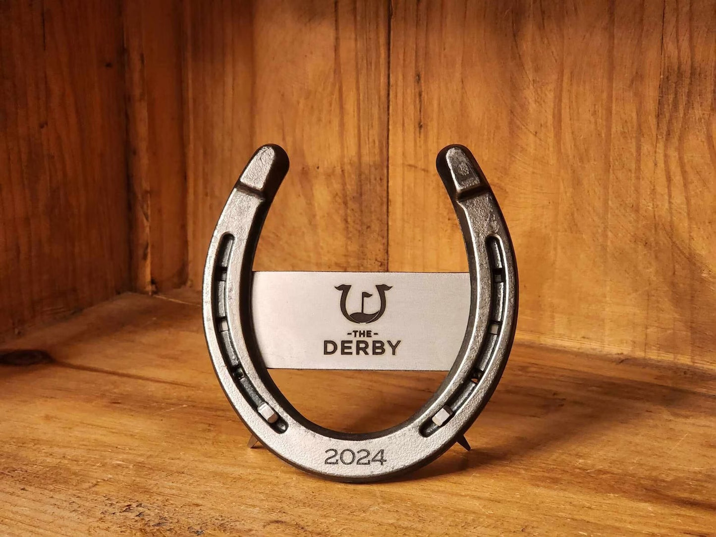 Real horseshoe with a company logo engraved on a metal piece welded to the back of the horseshoe. Referred to as "Design 2"