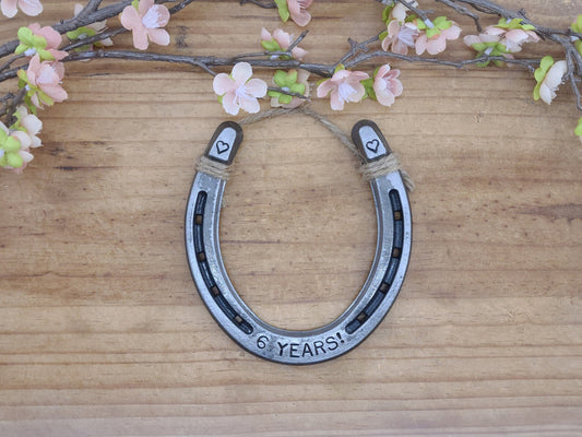 Real horseshoe with '6 YEARS!' stamped along the bottom and a heart stamped in each upper corner of the horseshoe.