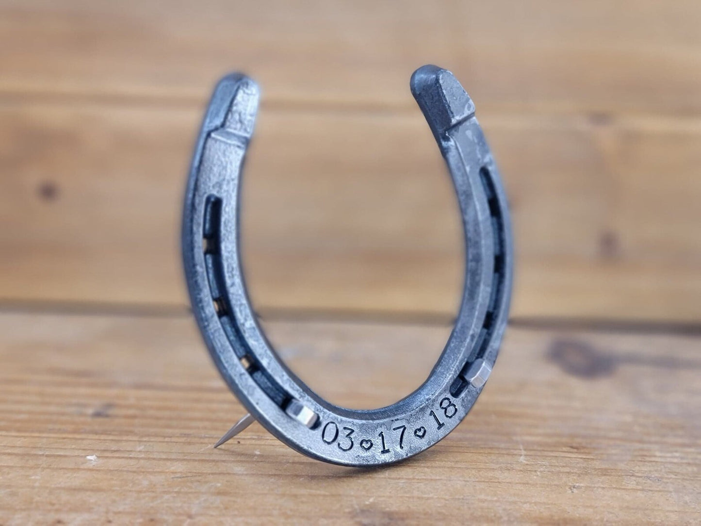 Freestanding real horseshoe personalized with a date along the bottom.