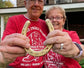 Real happy customers holding their gold anniversary horseshoe with their names and wedding date.