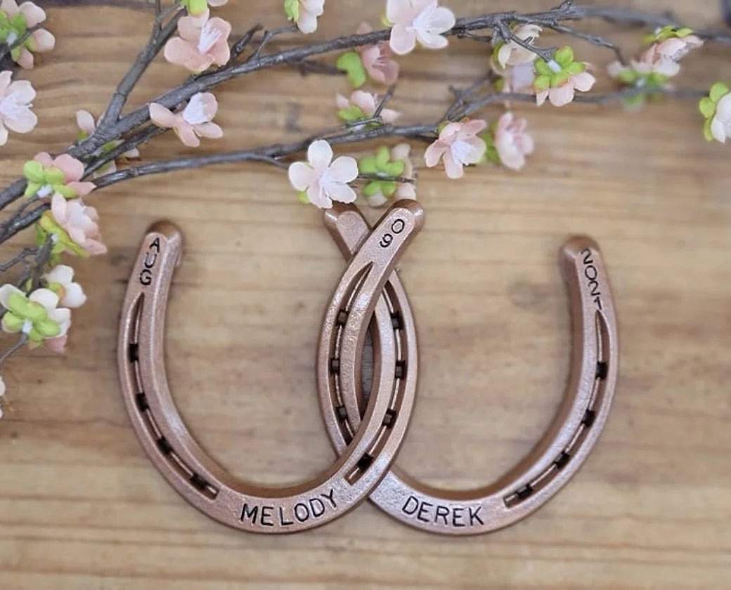 Real horseshoes painted copper to celebrate the 7 year anniversary. Personalized with names along the bottom and wedding date along the top.