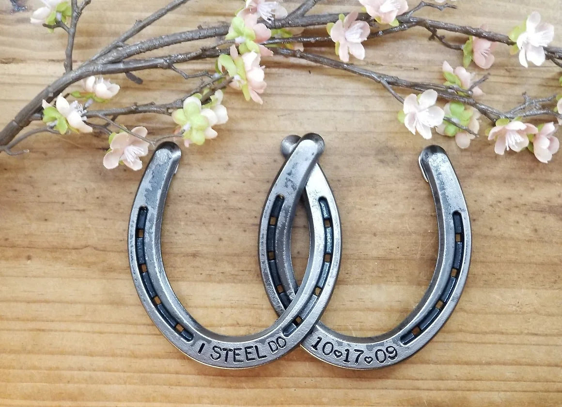 Real horseshoes welded together to commemorate the "steel" 11 year anniversary. Engraved with 'I STEEL DO' on one shoe and a custom wedding date on the other. Designed to hang.