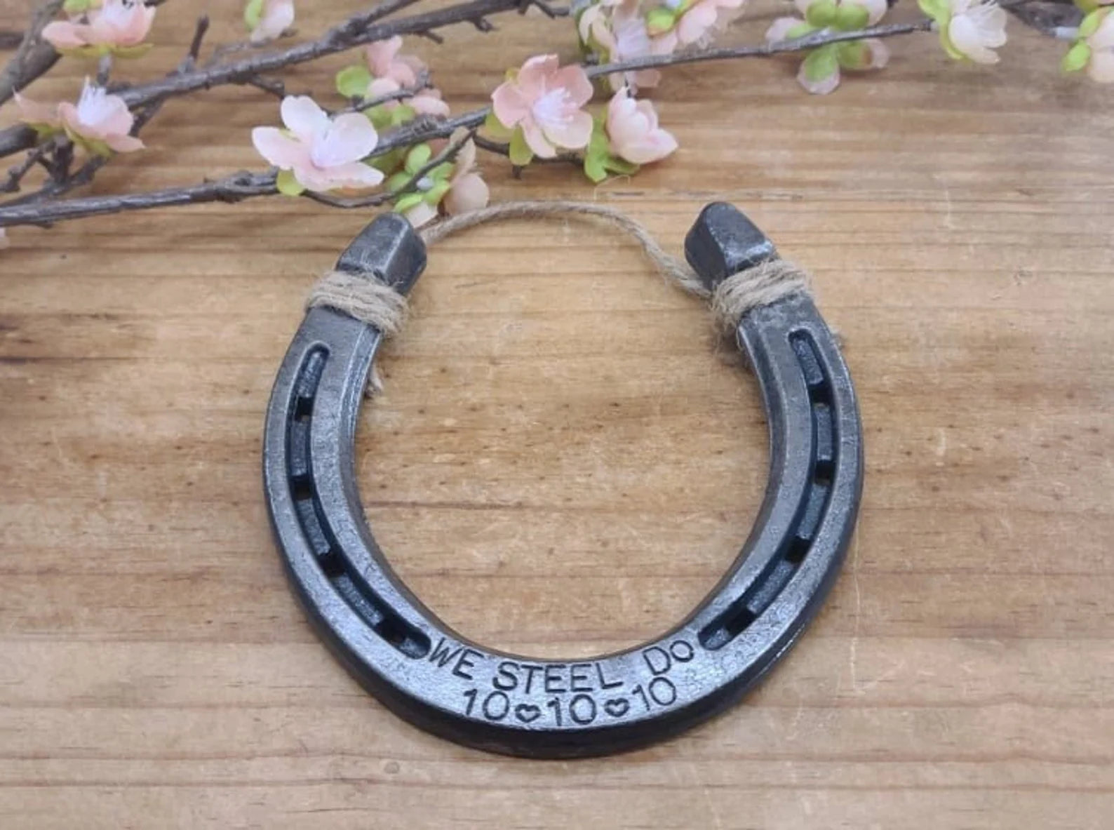 Real horseshoe decor with 'WE STEEL DO' and a wedding date engraved along the bottom.